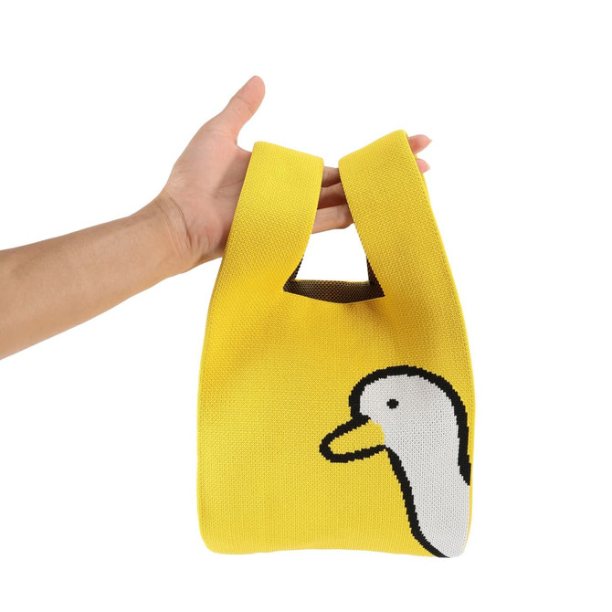 A yellow knitted handbag featuring a white duck design and a unique handle style. It has a logo on the side.