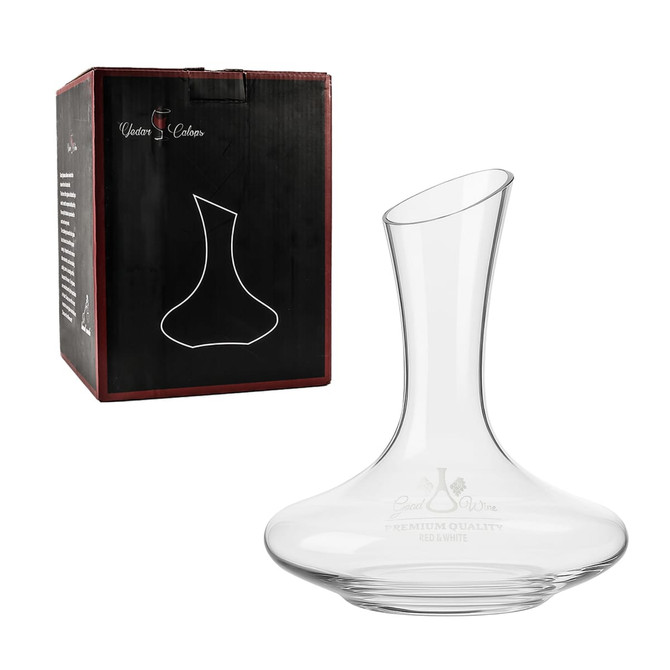 A glass wine decanter with a sleek design, displayed beside its packaging featuring a logo.