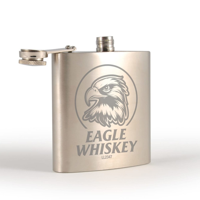 A stainless steel hip flask with a sleek silver finish and a logo featuring an eagle design.