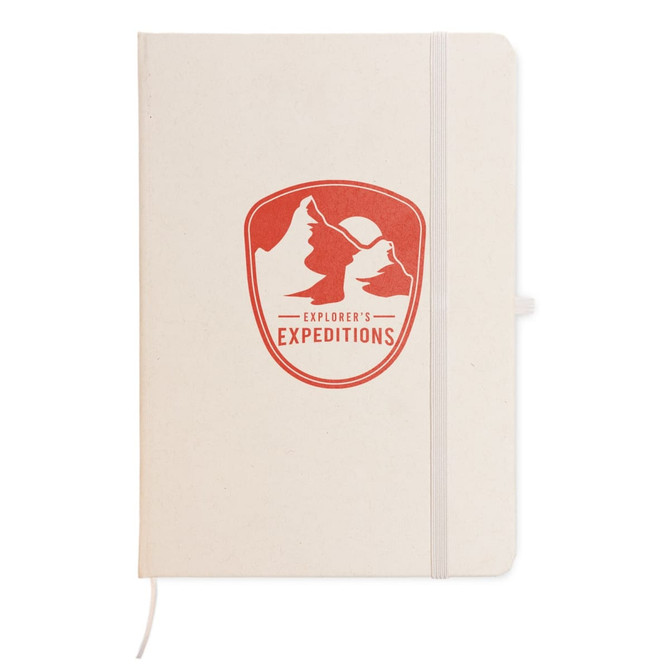 A cream-colored A5 notebook with a red logo featuring mountains on the front cover and an elastic band closure.