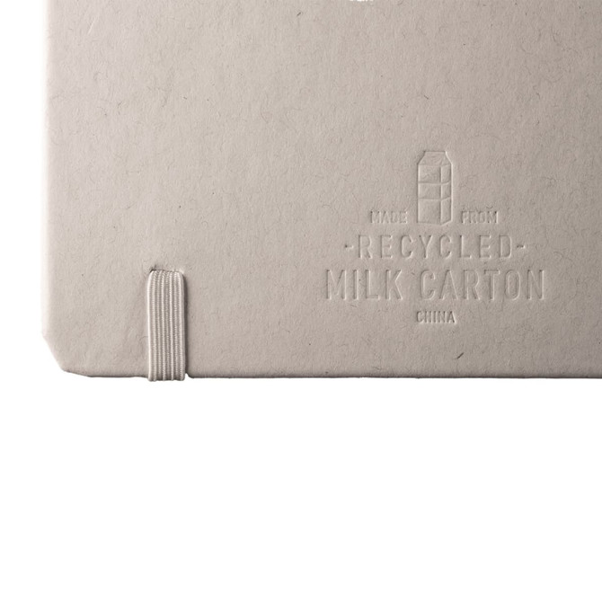 A recycled milk carton notebook with a textured grey cover and elastic band closure. It features branding on the back.