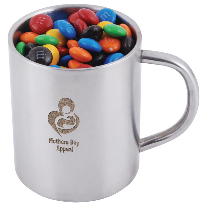 A stainless steel mug filled with colorful M&M's candies, featuring a logo that reads "Mothers Day Appeal."
