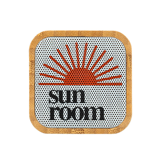 A bamboo Bluetooth speaker with a circular design featuring an orange sun graphic and 'sun room' text.