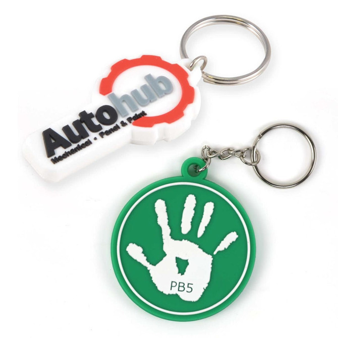 A set of two keytags: one white with a logo and one green with a handprint design. Both have metal keyrings.