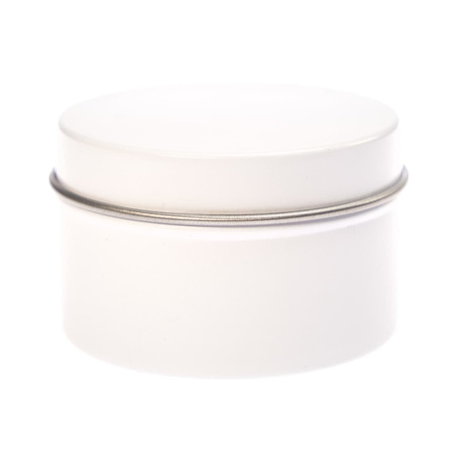 A petite candle in a simple, white tin container with a smooth lid. The tin is cylindrical in shape.