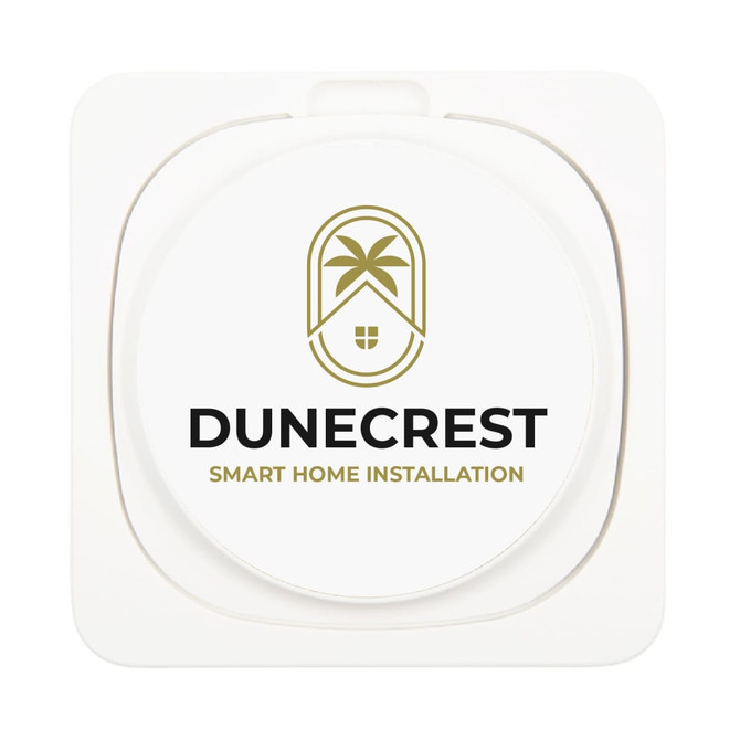 A wireless charger with a circular design featuring the logo for Dunecrest Smart Home Installation.