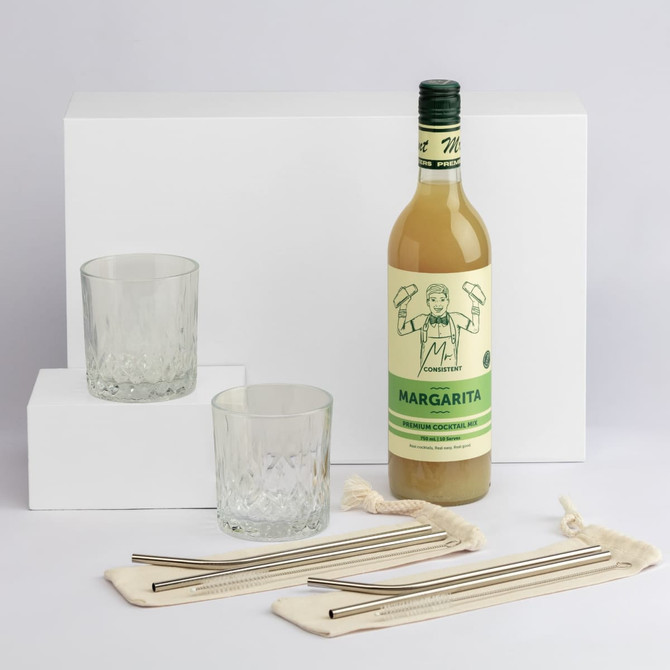 A drink bottle of Margarita with two glasses and stainless steel straws on a white background. The bottle is green and yellow.