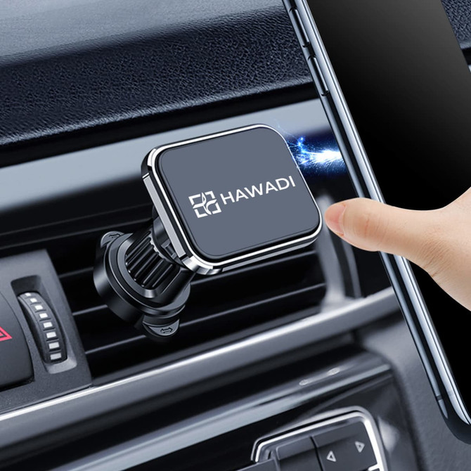 A car hook bracket in black and silver, attached to an air vent, with a hand placing a smartphone nearby.