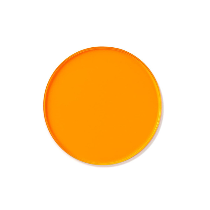 An orange custom tinted acrylic coaster with a smooth, round surface and a glossy finish.