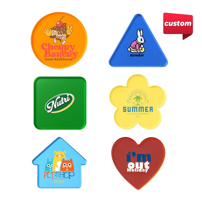 A collection of custom tinted acrylic coasters in various shapes and colours, featuring different logos and designs.