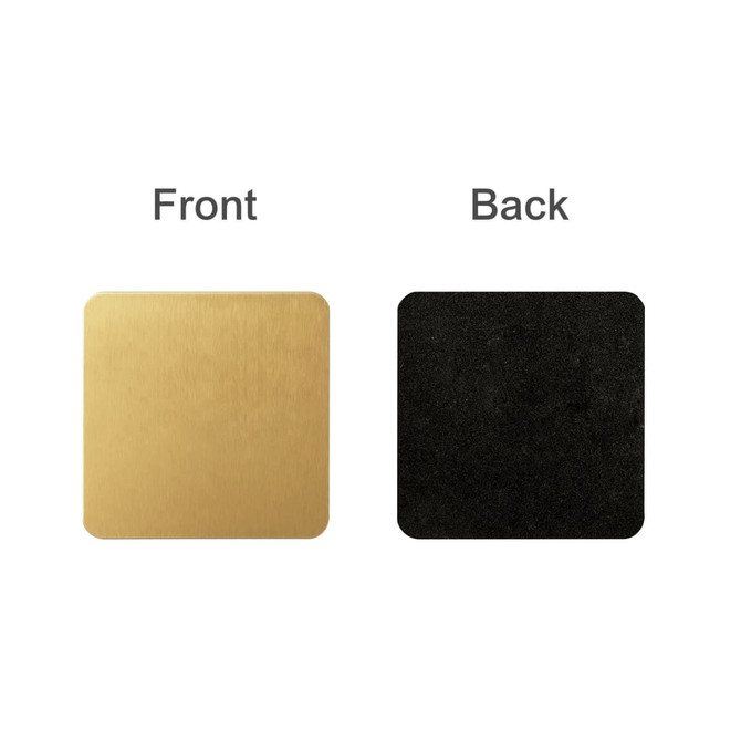A square metal coaster in gold on one side and black on the other, featuring a logo.