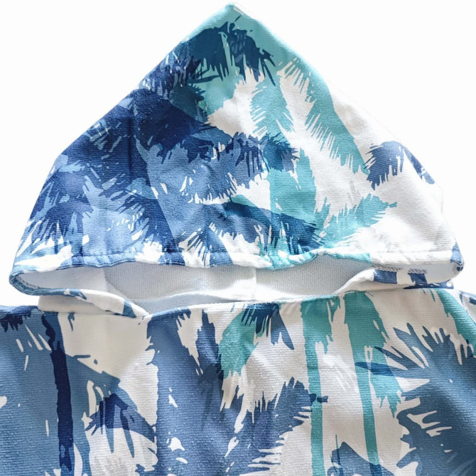 A hooded change towel in blue and aqua with a palm tree design, featuring a prominent hood.