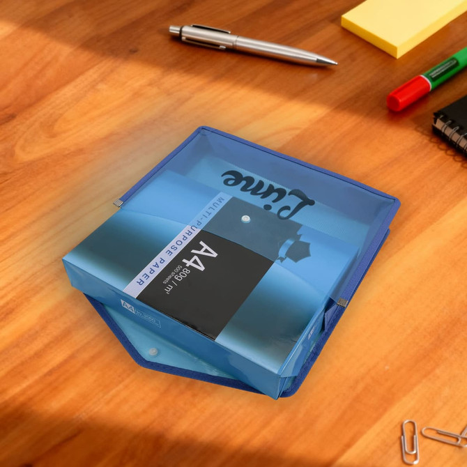 A blue expanding document folder with a transparent cover, resting on a wooden desk alongside stationery items.