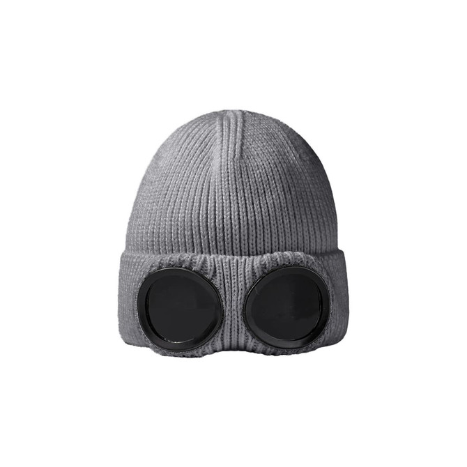 A grey beanie featuring large black goggles on the front, with a textured knit design. It includes a logo.