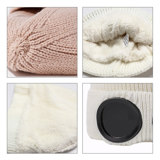 A pink knitted beanie with a white faux fur lining and a black goggle attachment. Features cosy textures and colours.