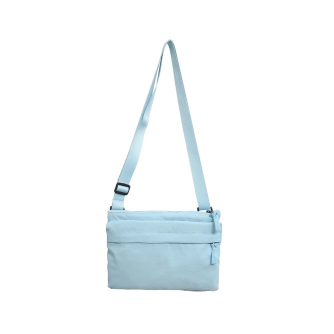 A lightweight crossbody bag in light blue with an adjustable strap and a zippered pocket. It features a logo.