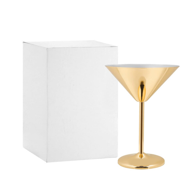 A stainless steel martini goblet in a shiny gold finish, beside a white box.