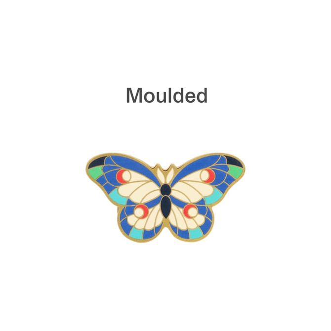 A moulded metal clip featuring a vibrant butterfly design with blue, green, red, and cream colours.