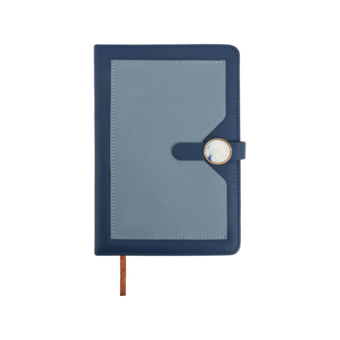 A navy blue pocket notebook with a magnetic buckle closure and a decorative circular element on the front.
