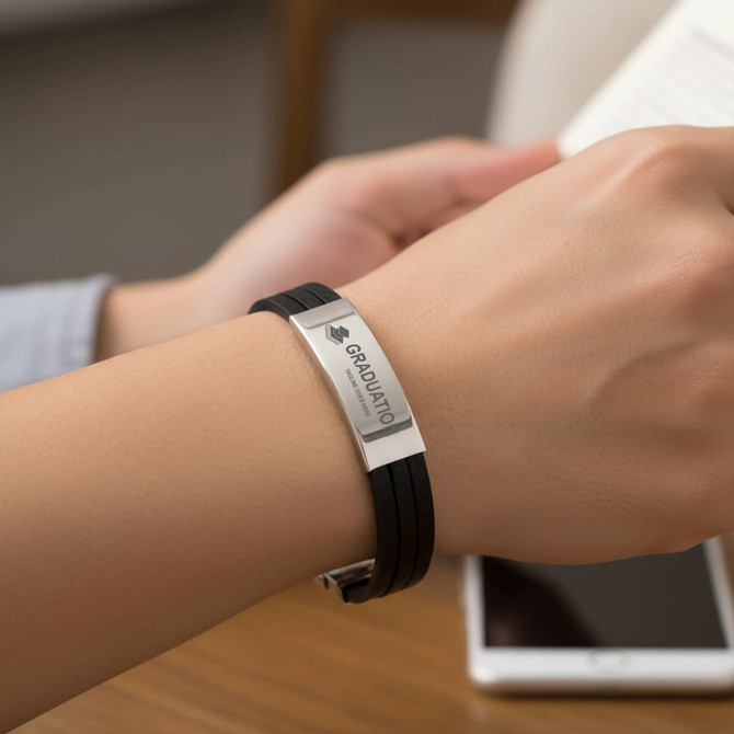 A black multi-layer leather bracelet featuring a silver clasp and an engraved plate.