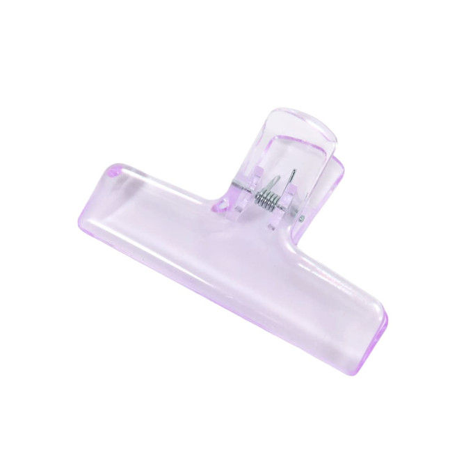 A translucent purple plastic clip with a spring mechanism for securing items.