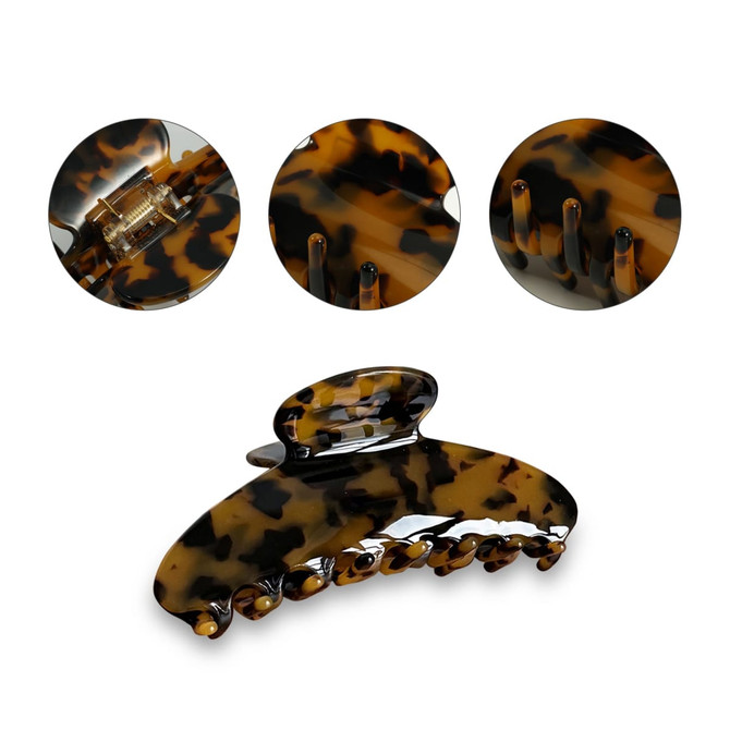 A tortoiseshell acetate hair clip with a glossy finish, featuring multiple gripping teeth and a compact design.