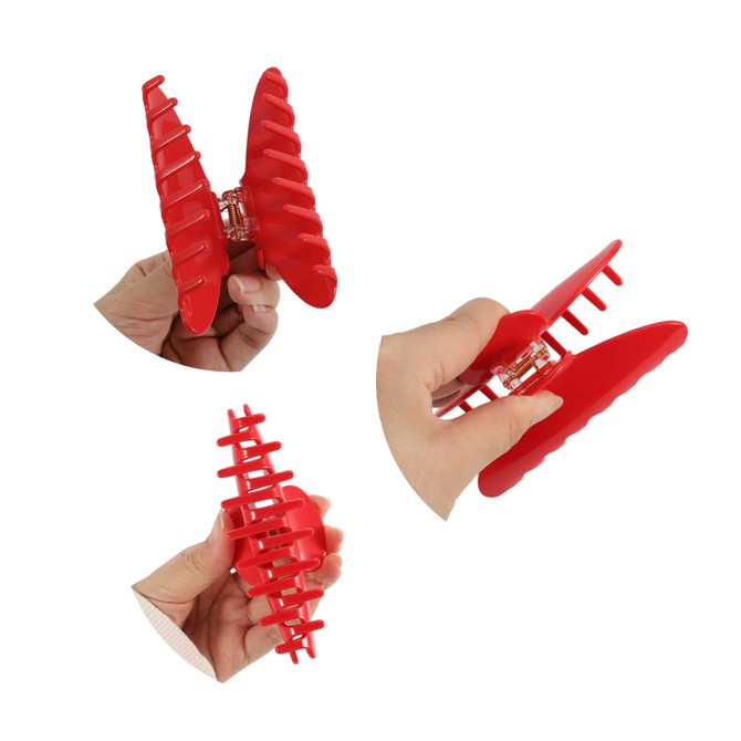Three red acetate hair clips are shown from different angles, featuring a ribbed design and a clasp mechanism.