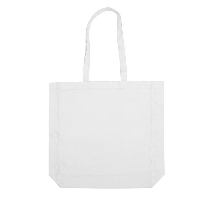 A white calico tote bag with long handles and a simple design. It features a logo or branding.