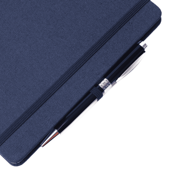 A fabric-covered A5 notebook in navy blue, featuring a silver pen resting on top.