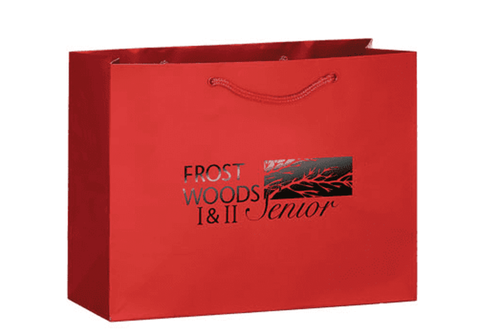A red landscape tote bag featuring a logo on one side and two handles for carrying.