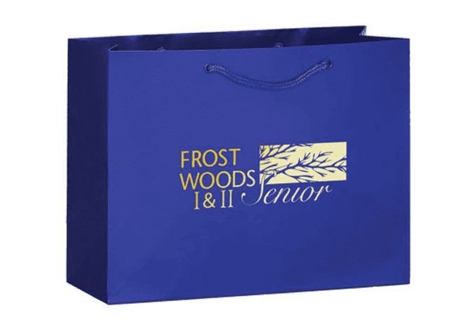 A blue tote bag with a logo displayed prominently on the front, featuring a design element.