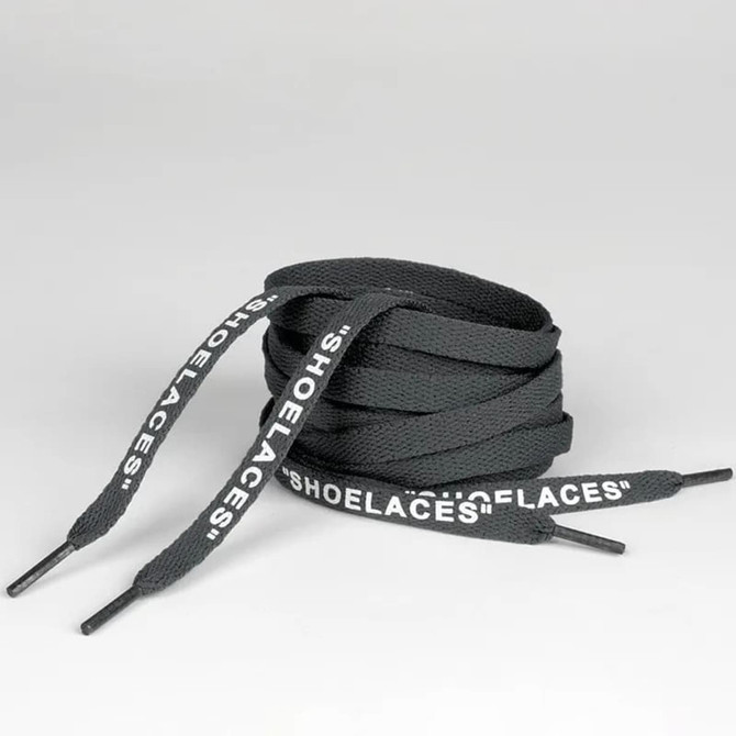 A pair of grey printed shoelaces, coiled neatly with black tips, featuring a branding logo.