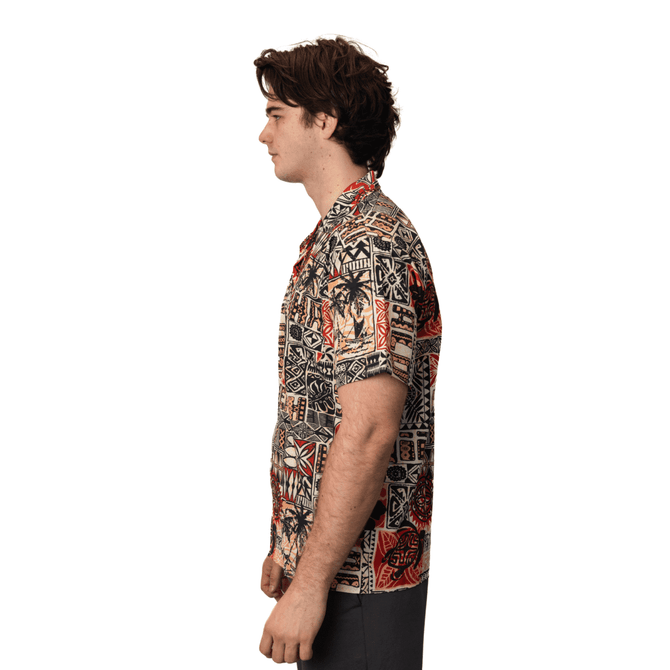 A button-up shirt featuring a vibrant, patterned design in shades of red, black, and beige. It has a logo on it.