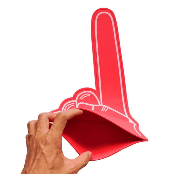 A red EVA foam supporter hand in the shape of a raised hand, held by a hand. It features a simple design with no text.