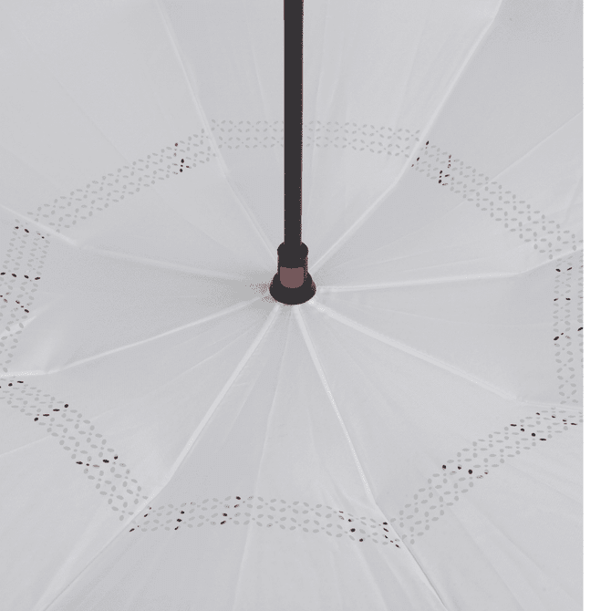 An inverted umbrella with a white canopy and a black handle features decorative edge detailing.