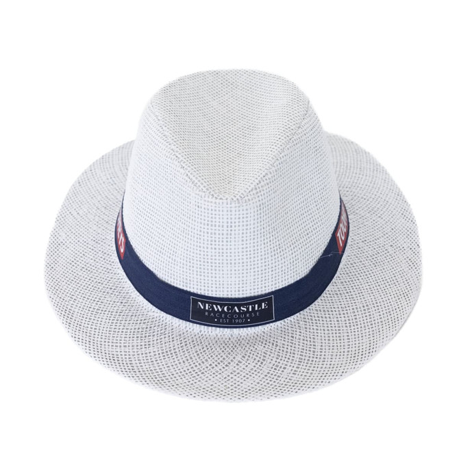 A white straw hat with a navy band and logo, featuring a classic fedora shape.