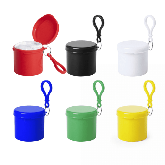 A collection of six round containers in red, black, white, blue, green, and yellow, each featuring a carabiner clip.