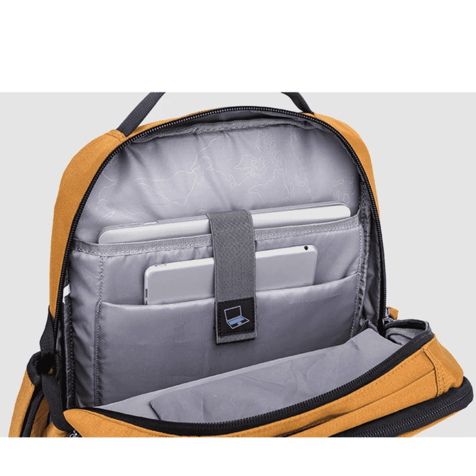 An open golden-yellow backpack displaying a grey interior with compartments for laptops and tablets, featuring a logo.