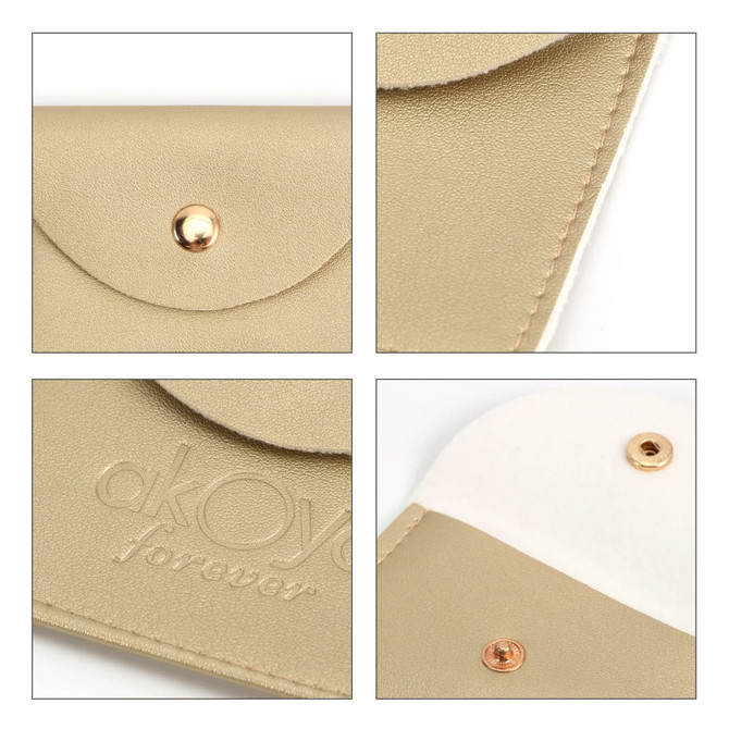 A square, beige PU leather jewelry pouch featuring a gold snap closure and a white interior. Includes a logo.