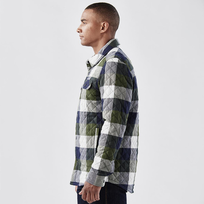 A men's quilted shacket in green, grey, and navy check pattern, featuring a side view of the model.
