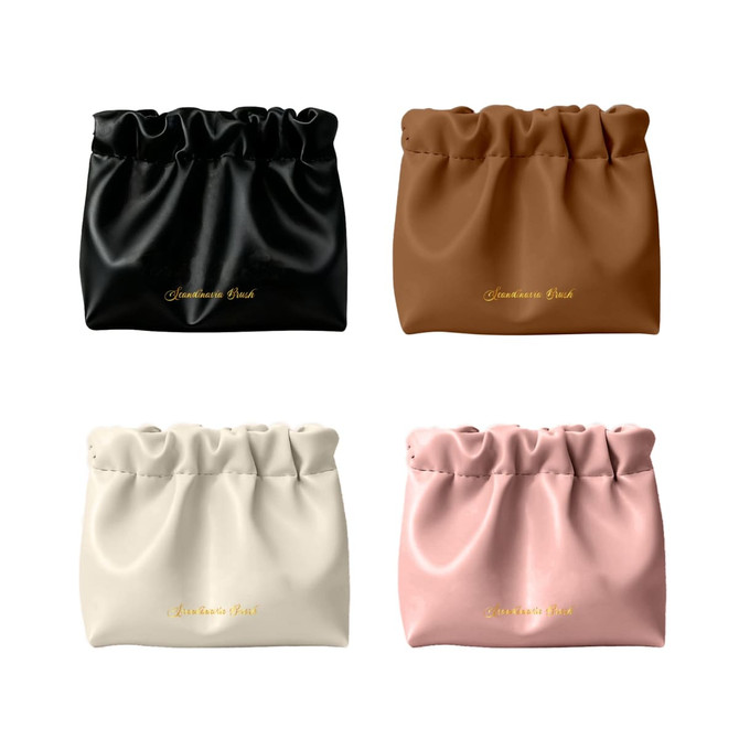 A selection of four Zipperless Portable Makeup Bags in black, brown, white, and pink, featuring a gathered design.