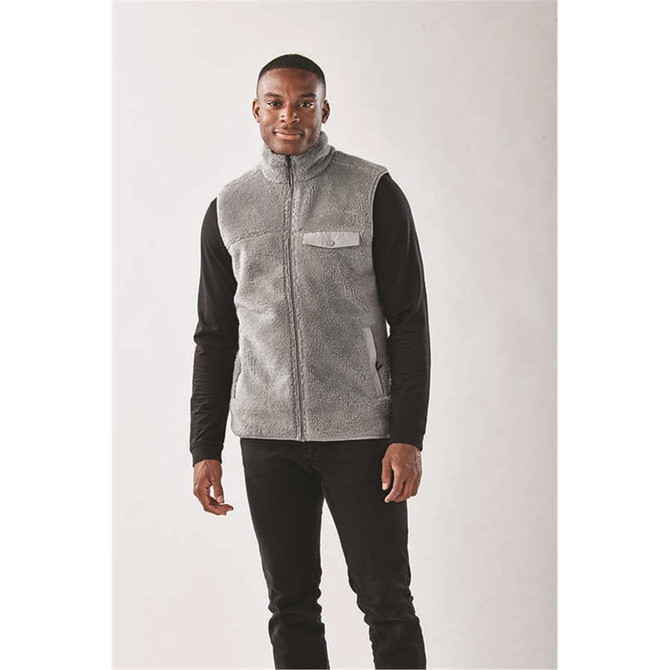 Men's Bergen Sherpa fleece vest in light grey, featuring a zip-up front and a chest pocket. Black long-sleeve shirt underneath.