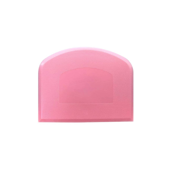 A pink flexible bowl scraper with a textured surface and a rounded top, featuring a logo.