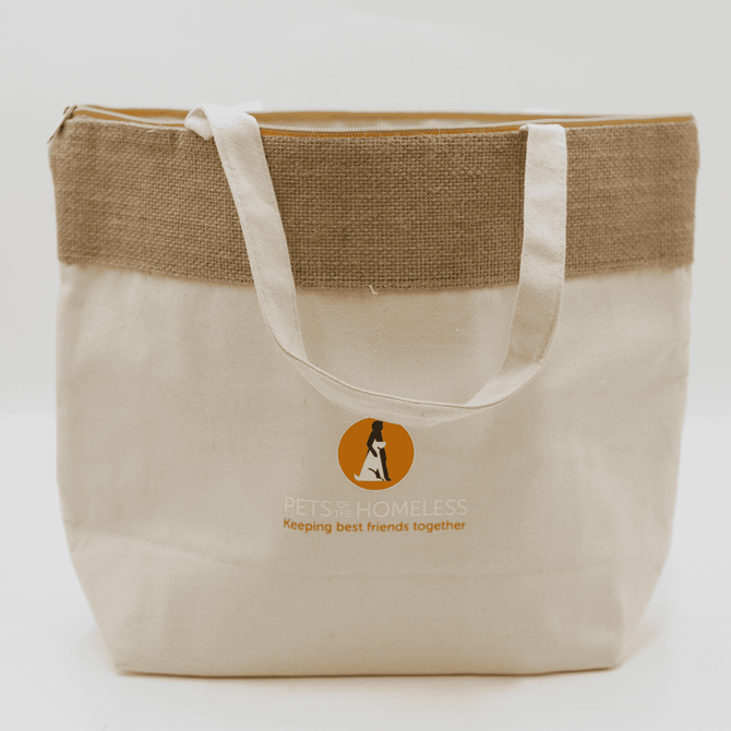 A jute and cotton cooler bag in natural and beige colours, featuring a logo on the front.