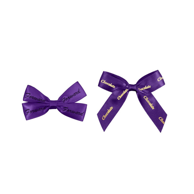 Two purple adhesive bows, one with "Forward" and the other with "Chocolate" in gold lettering.