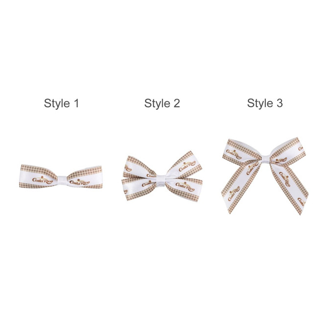 Three hair clip bows in white and brown patterns, featuring different styles with varying ribbon arrangements.