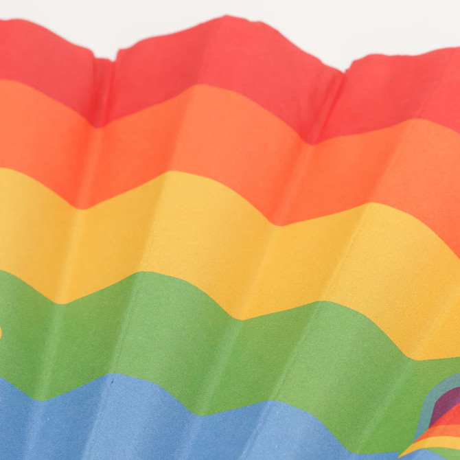 A paper hand-held fan featuring vibrant stripes of red, orange, yellow, green, and blue. It has a logo on it.
