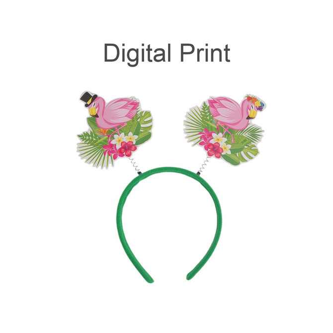 A headband with green fabric featuring pink flamingo decorations and tropical leaf designs on either side.