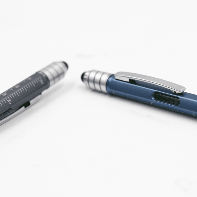 A blue and silver pen with a ruler and a textured grip, featuring a clip and a branding logo.