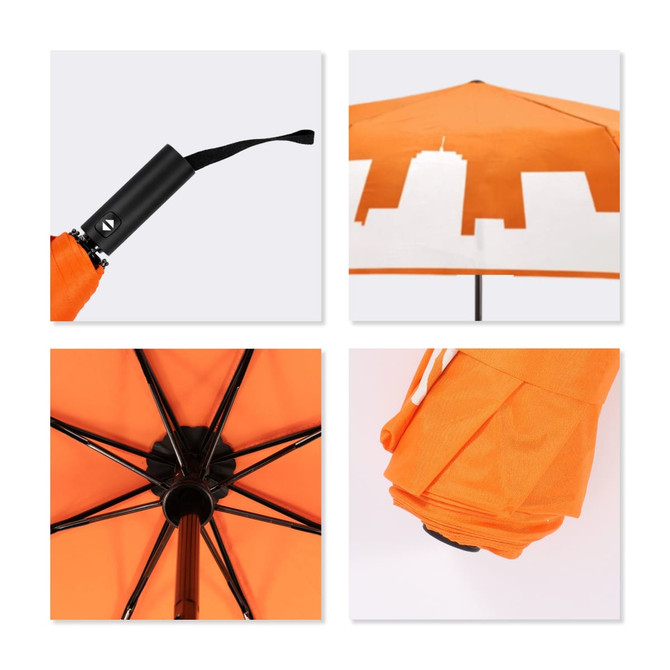 A 23'' colour changing umbrella featuring an orange canopy with a city skyline design and a black handle.